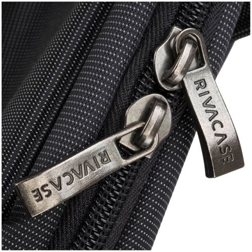 Close-up of two silver zipper pulls, labeled RIVACASE, on black fabric.