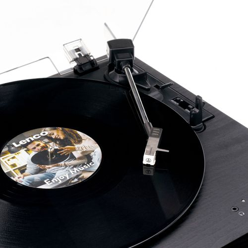 Black turntable with needle on record featuring a couple enjoying music.
