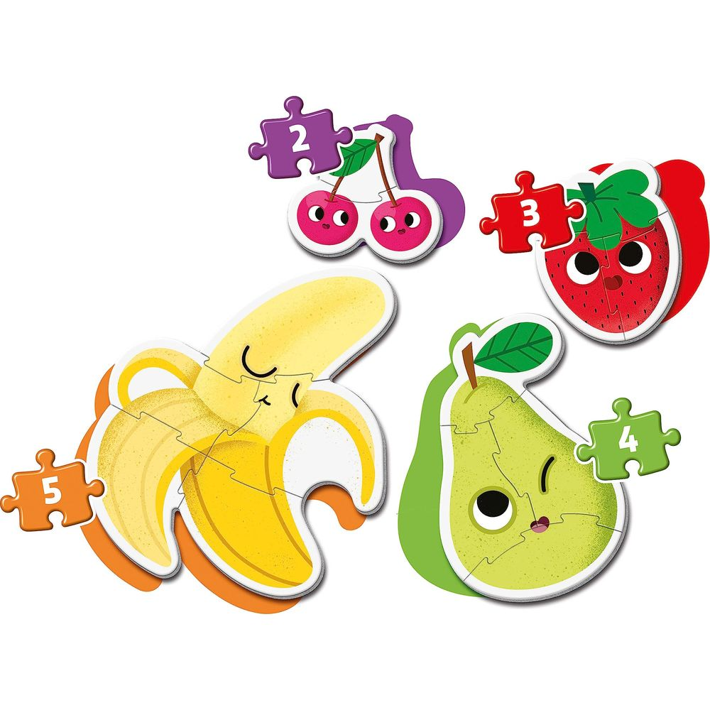 Pezzi di puzzle colorati di frutta: ciliegie, fragola, banana e pera.