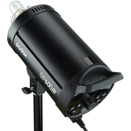 Flash da studio nero su stativo con controlli e lampadina.