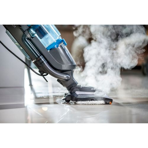 A steam cleaner cleans a shiny floor, producing steam.