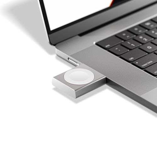 Un laptop argento con un caricabatterie bianco rotondo attaccato al lato.