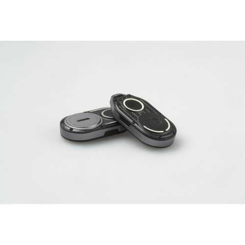 Two black and gray oval electronic devices are placed on a white surface.