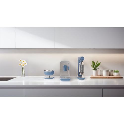 Ein blauer Wassersprudler, ein silberner Wasserspender, eine Schüssel und Blumen auf einer Küchentheke.