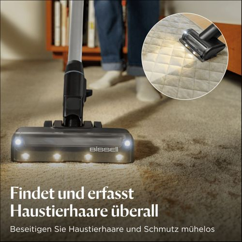 Aspirapolvere Bissell su tappeto con luci. Primo piano mostra la spazzola.