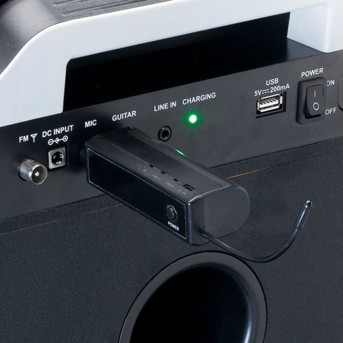 A black device with ports for FM, DC, MIC, GUITAR, USB, and POWER.