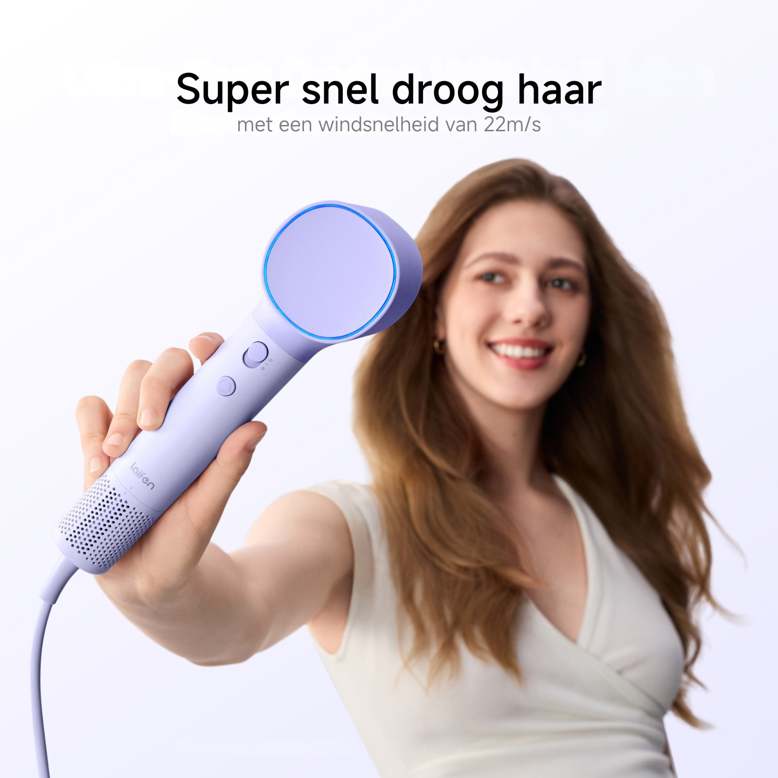 Eine Frau hält einen lila Haartrockner mit blauem Lichtring. Haar weht.