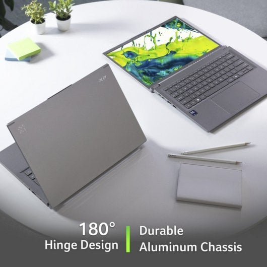 Dos portátiles Acer grises sobre una mesa blanca, uno abierto con pantalla verde y azul.