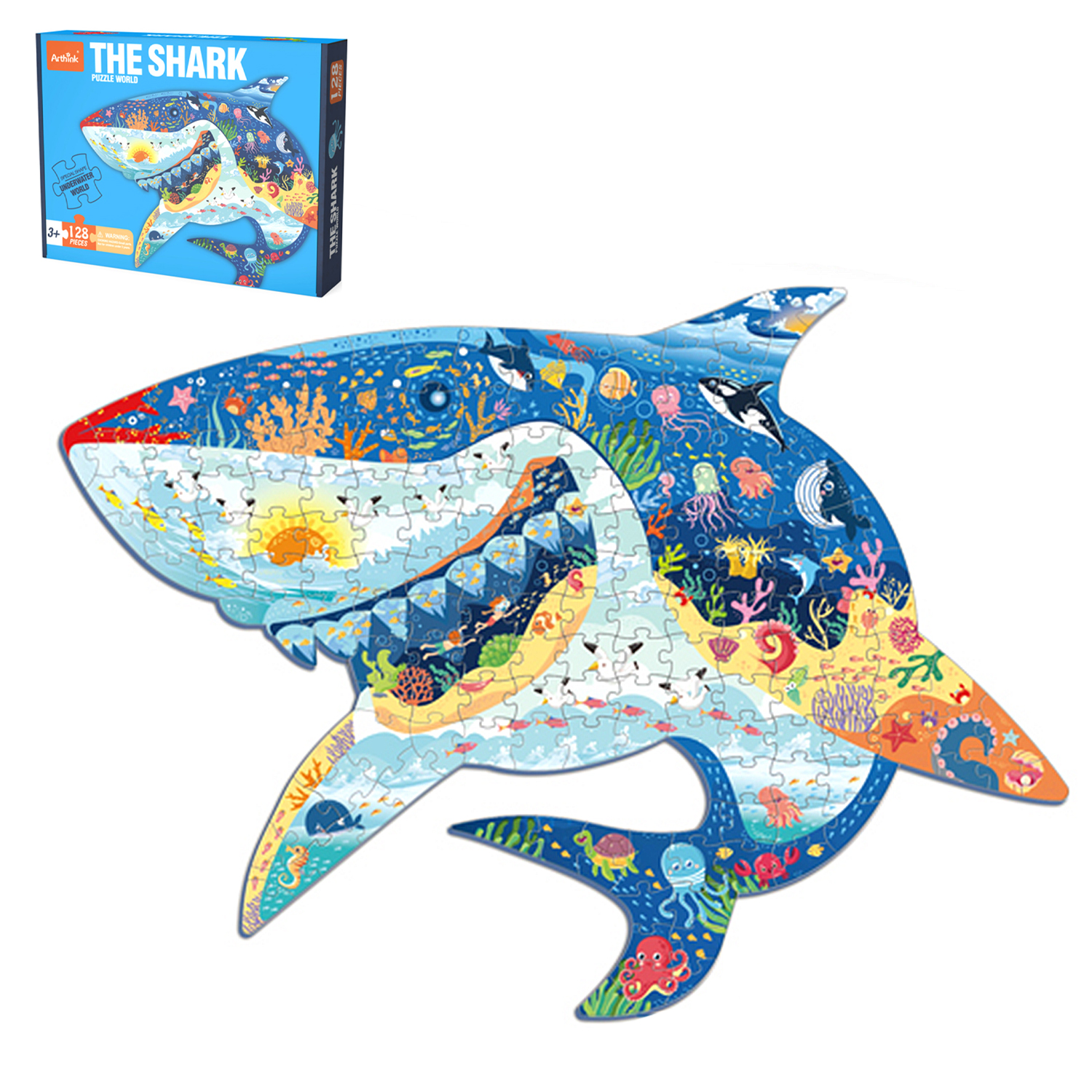 Un puzzle a forma di squalo raffigurante un mondo sottomarino, accanto alla sua scatola.