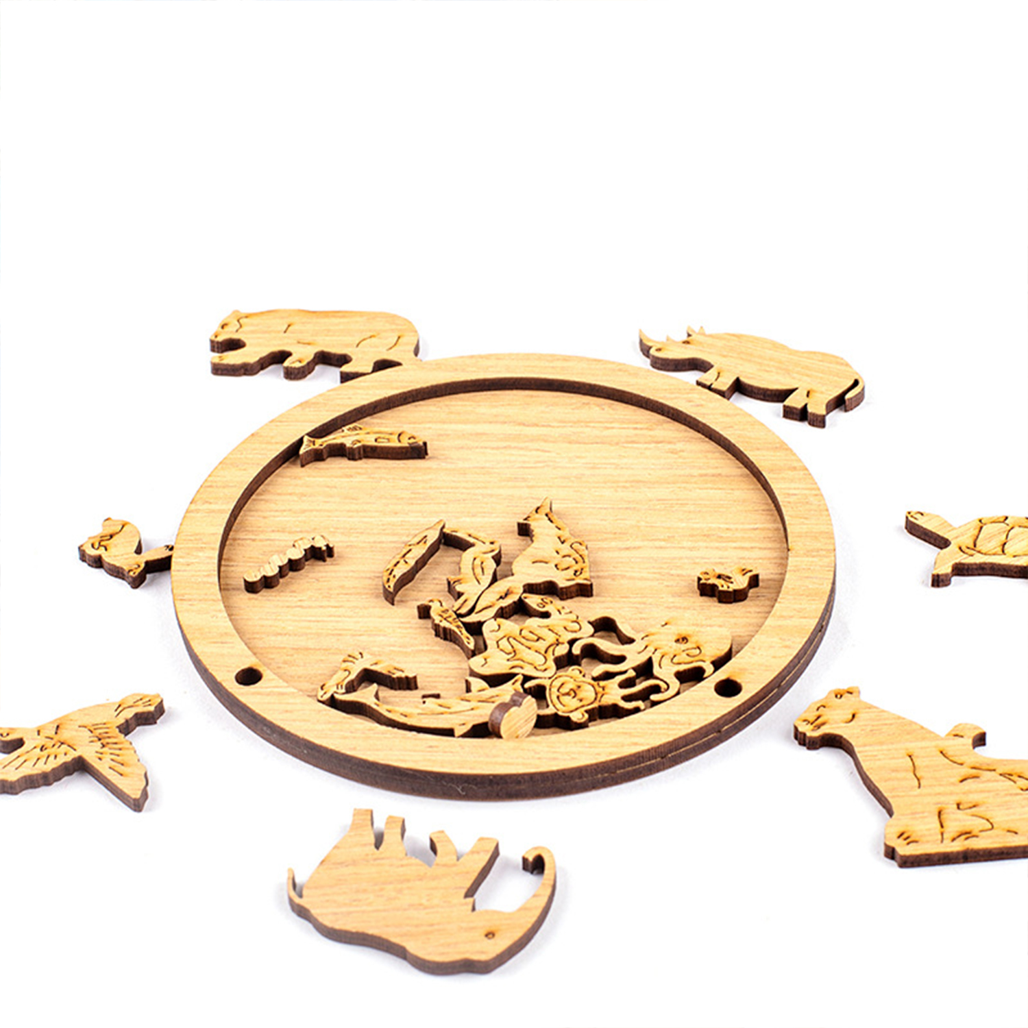 Pezzi di puzzle di animali in legno circondano una base rotonda in legno con pezzi all'interno.
