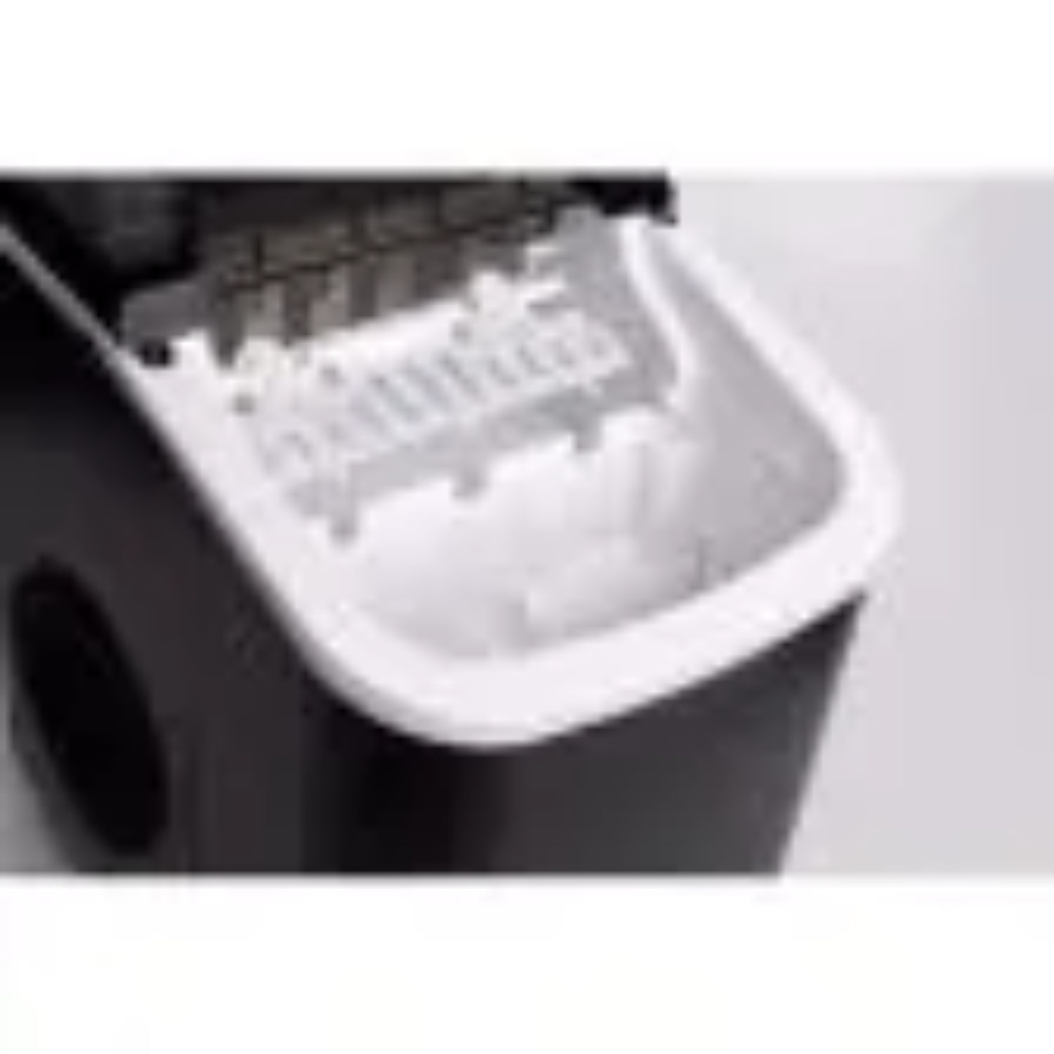 A black ice maker with its lid open, showing the white interior.