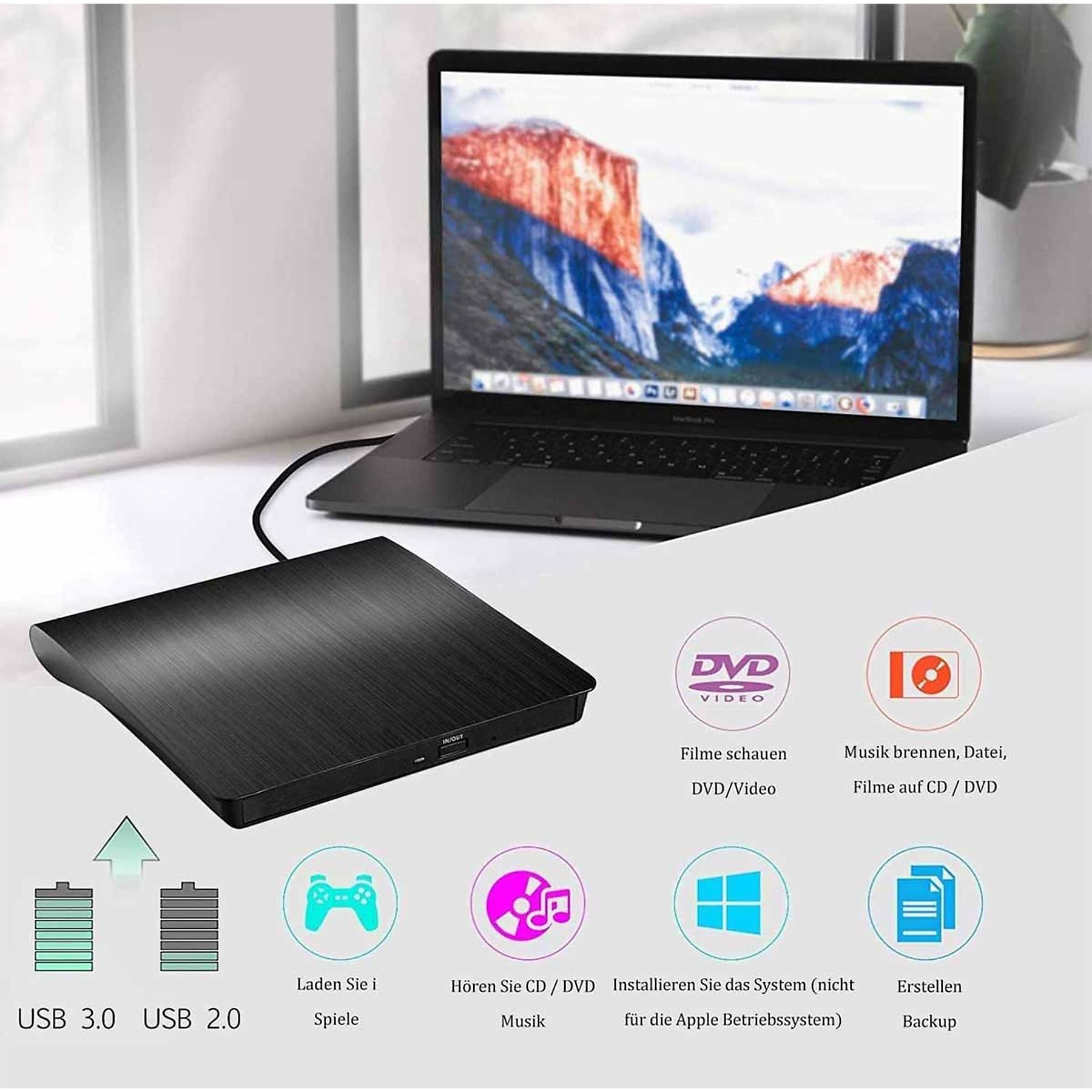 Schwarzer externer DVD-Brenner neben einem Laptop mit Berg-Hintergrundbild.