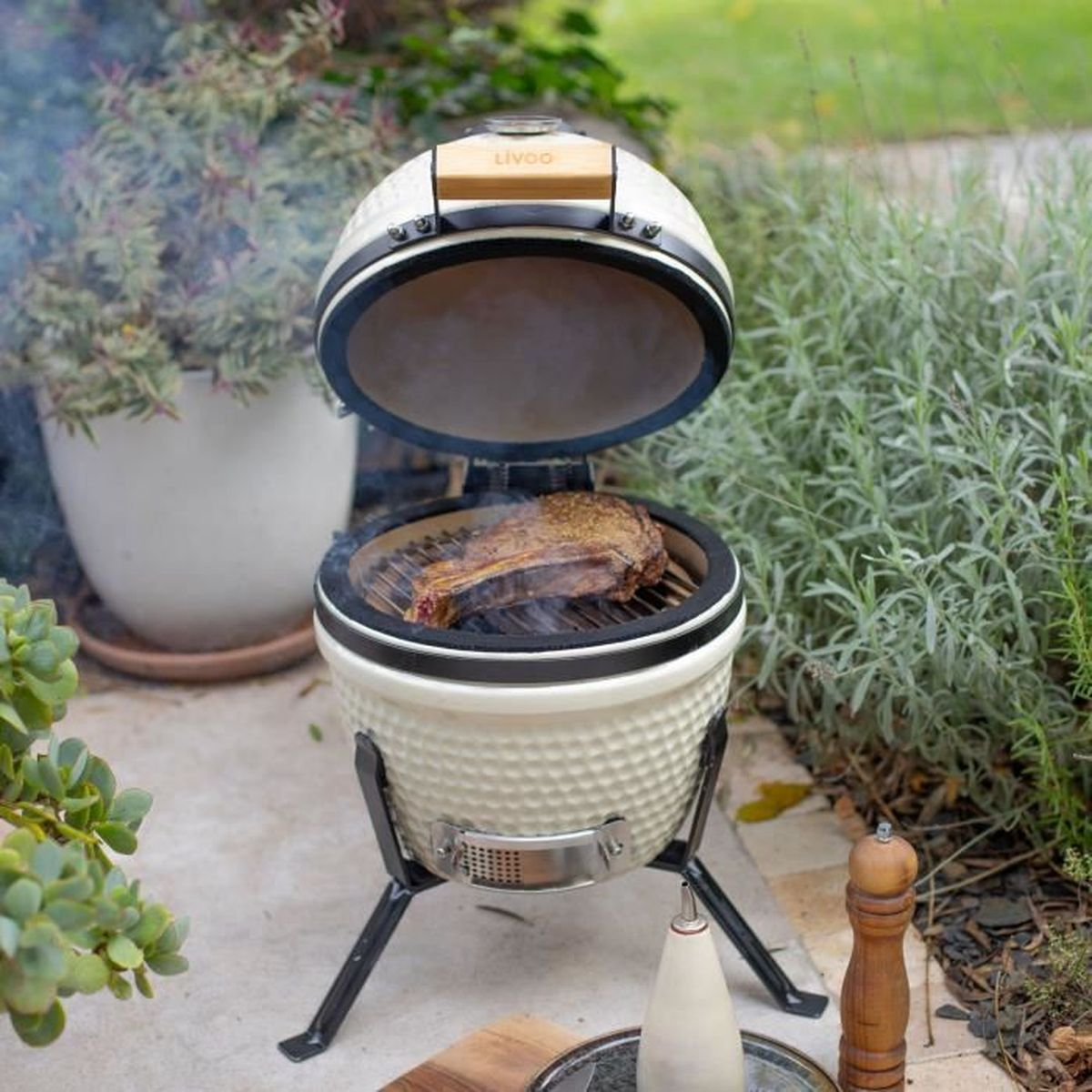 Una bistecca spessa alla griglia su un barbecue aperto, con fumo.