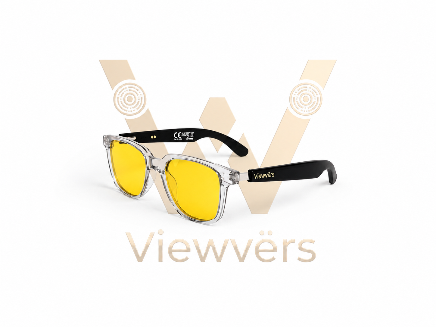 Gafas de sol con montura transparente, lentes amarillas y patillas negras. Logo al fondo.