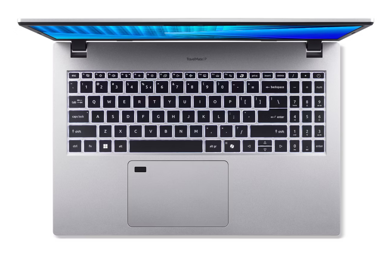 Widok z góry otwartego srebrnego laptopa z podświetlaną klawiaturą i niebieskim ekranem.