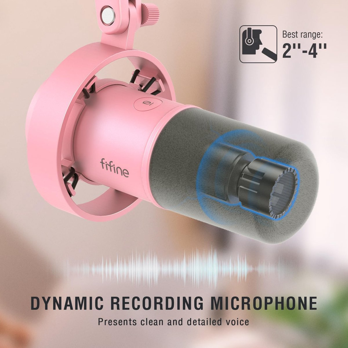 Un microphone rose avec une bonnette grise et un graphique d'onde audio. Meilleure portée 2-4 pouces.