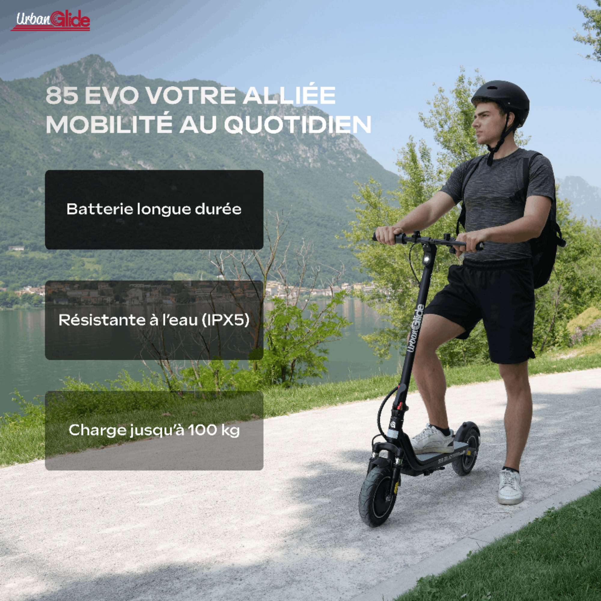 Un hombre en un patinete eléctrico en paisaje montañoso con lago.