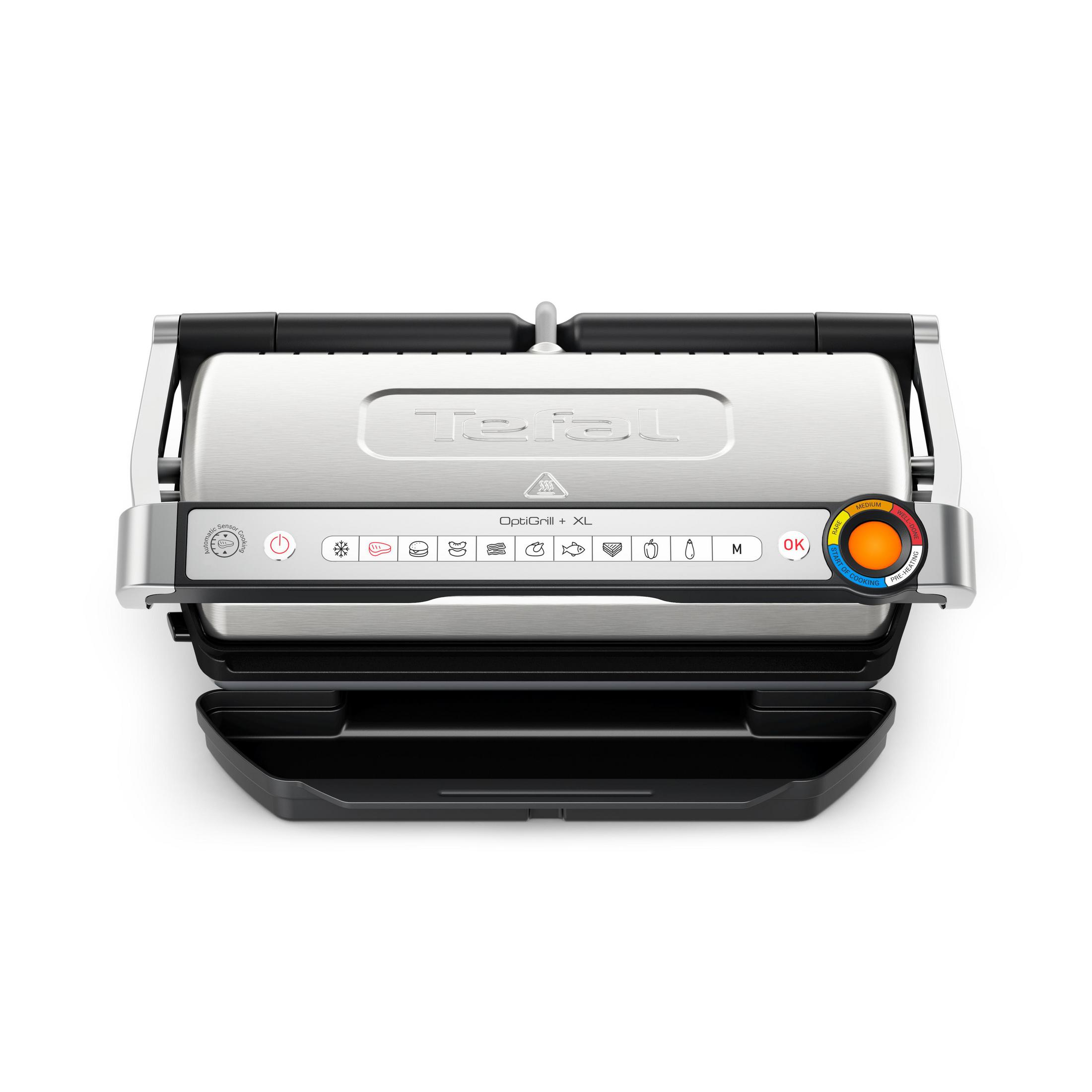 Una Tefal OptiGrill+ XL argentata con vaschetta raccogligocce nera, programmi e selettore temperatura.
