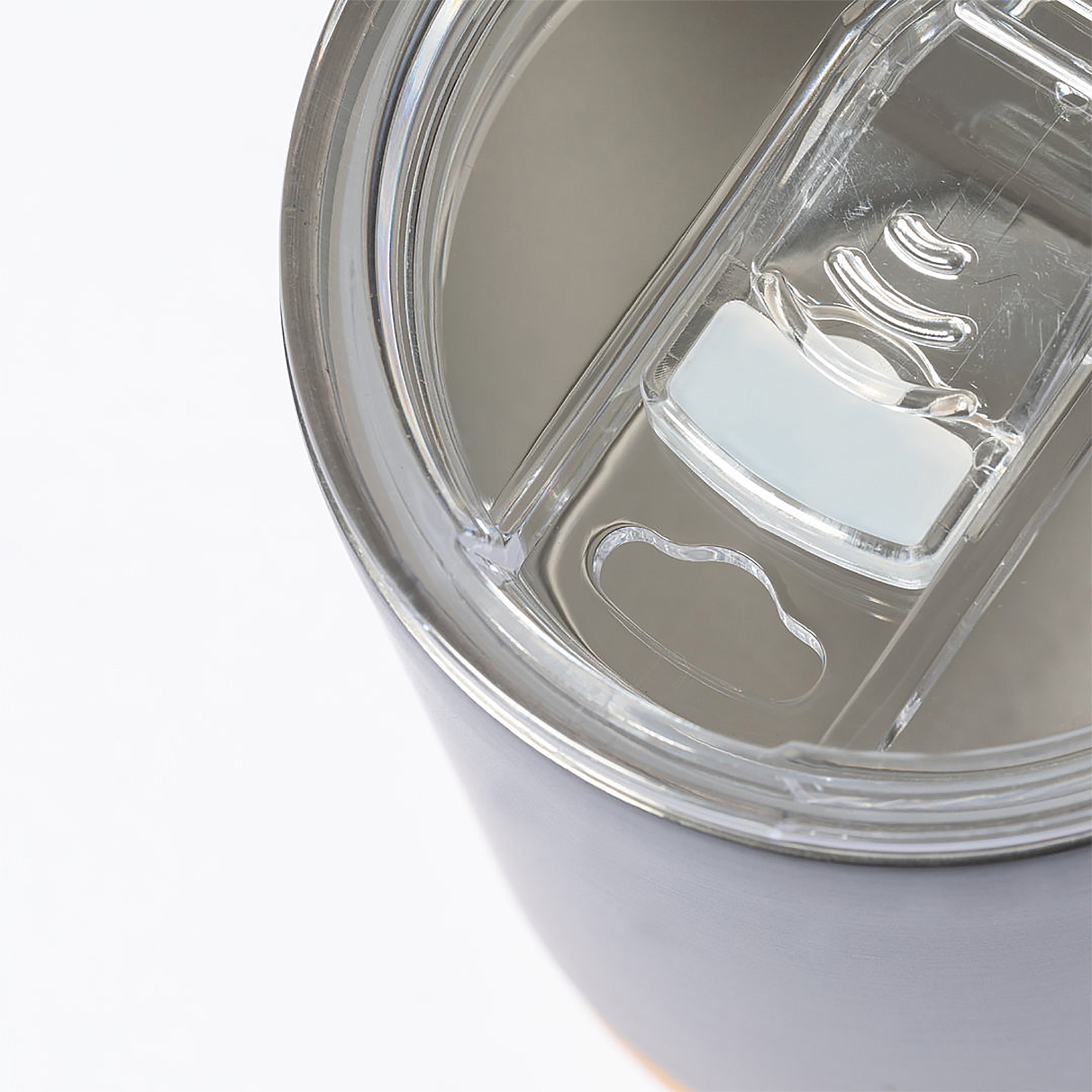 Primer plano de la tapa transparente de un vaso con apertura para beber.