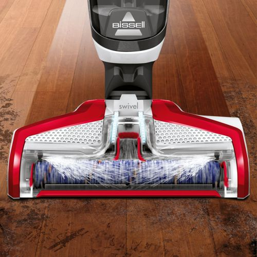 Bissell Bodenreiniger mit rot-weißer Bürste auf Holzfußboden.