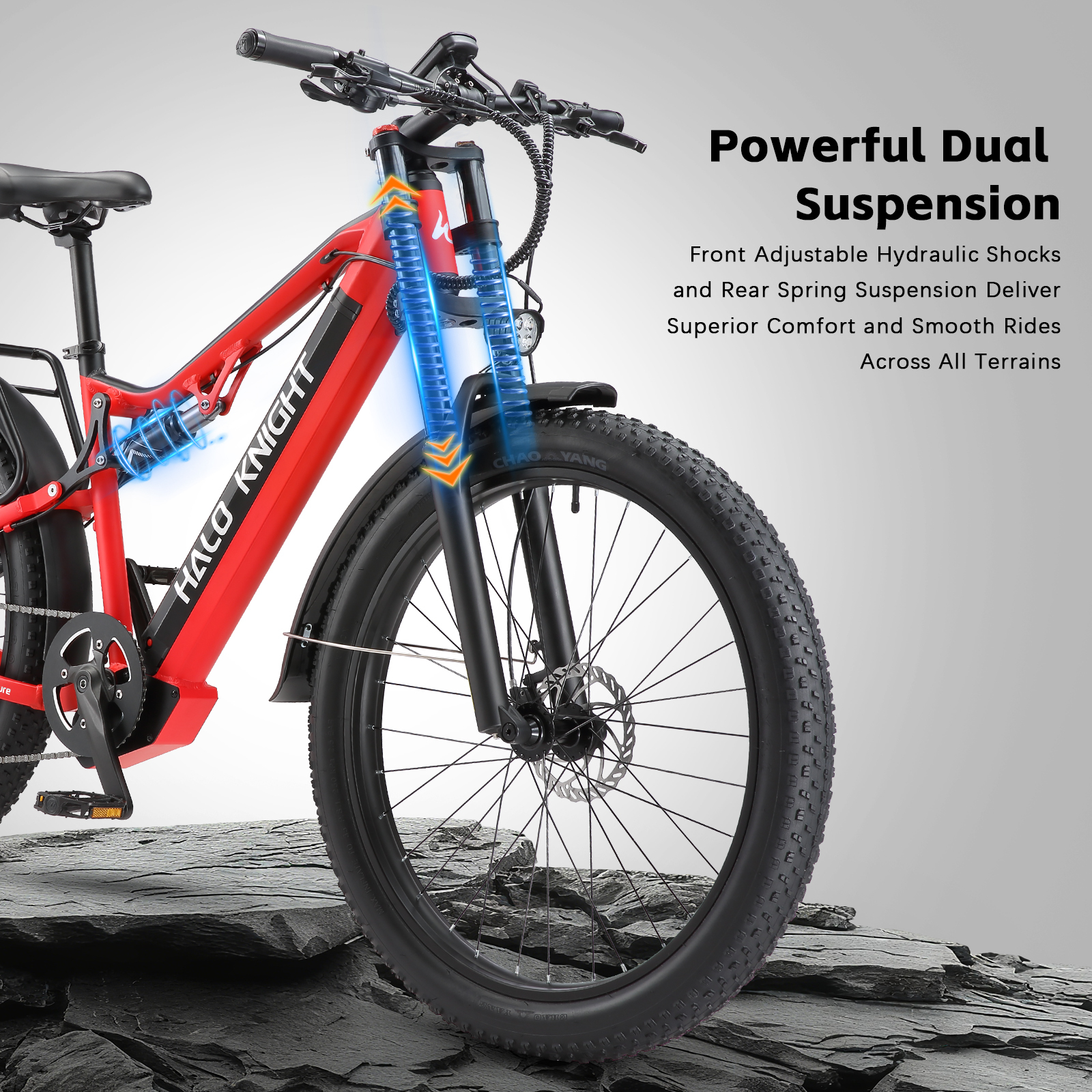 Una bicicleta eléctrica roja con doble suspensión sobre piedra.