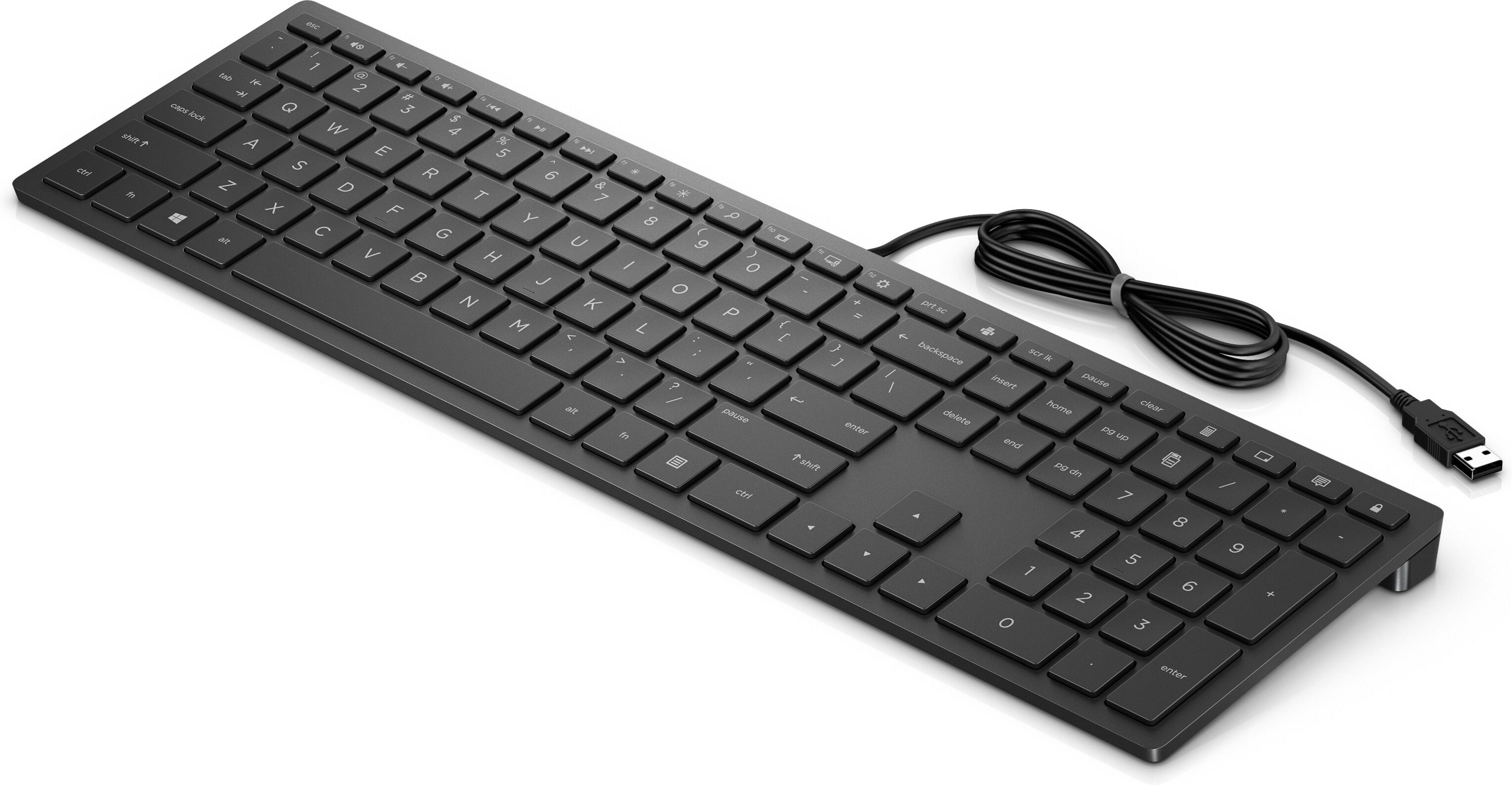 A black USB keyboard with a number pad rests on a white background.