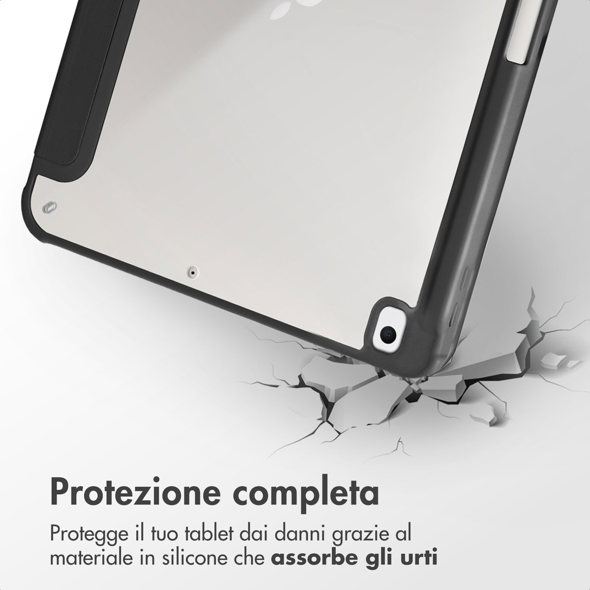 Black tablet case with clear back, lying on cracked ground.