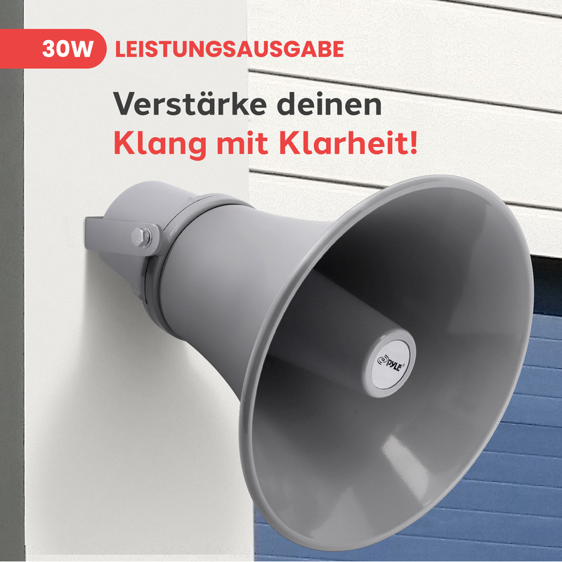 Grauer Lautsprecher an weißer Wand. "30W Leistungsabgabe" steht oben.