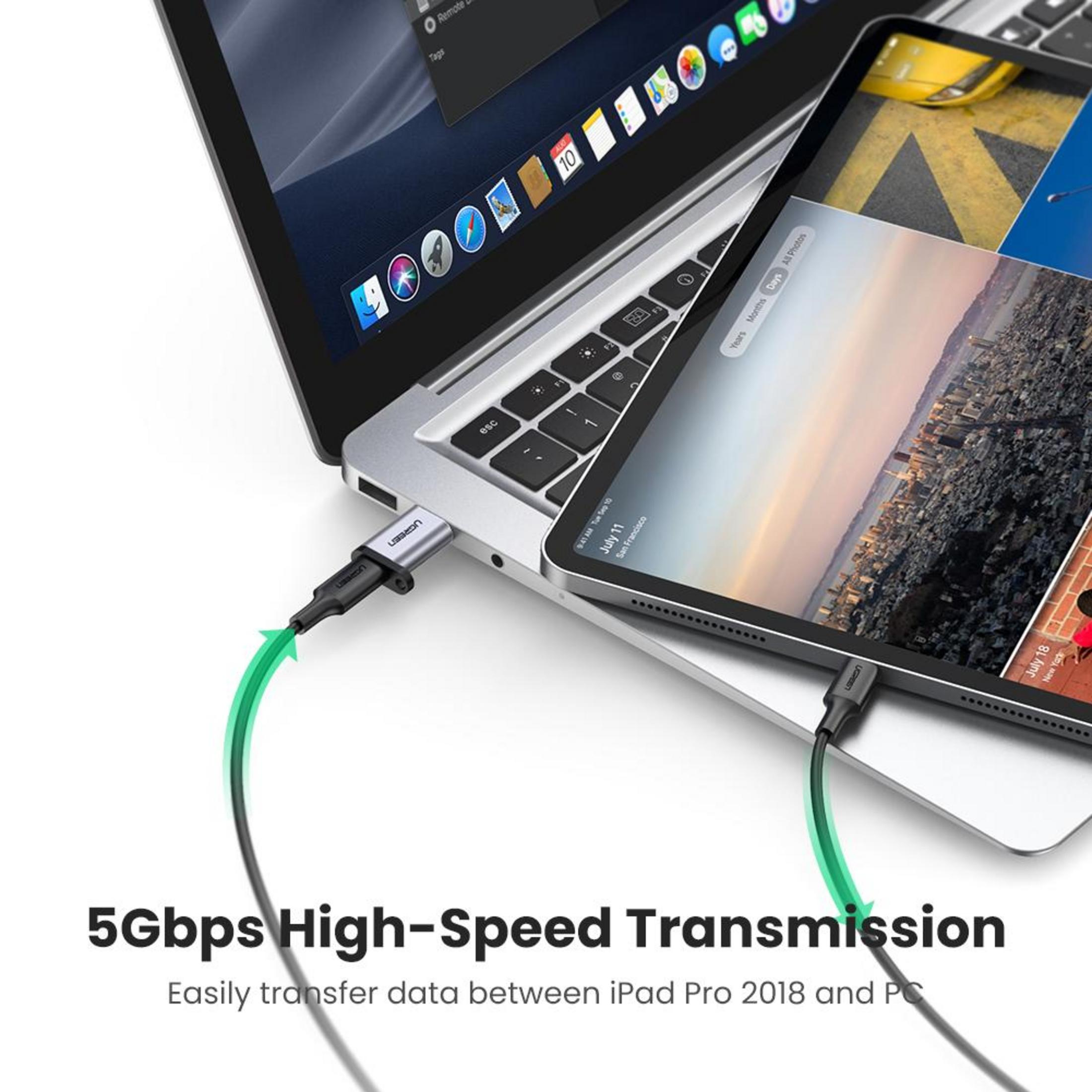 Un portátil está conectado a una tableta. Un cable conecta ambos dispositivos.
