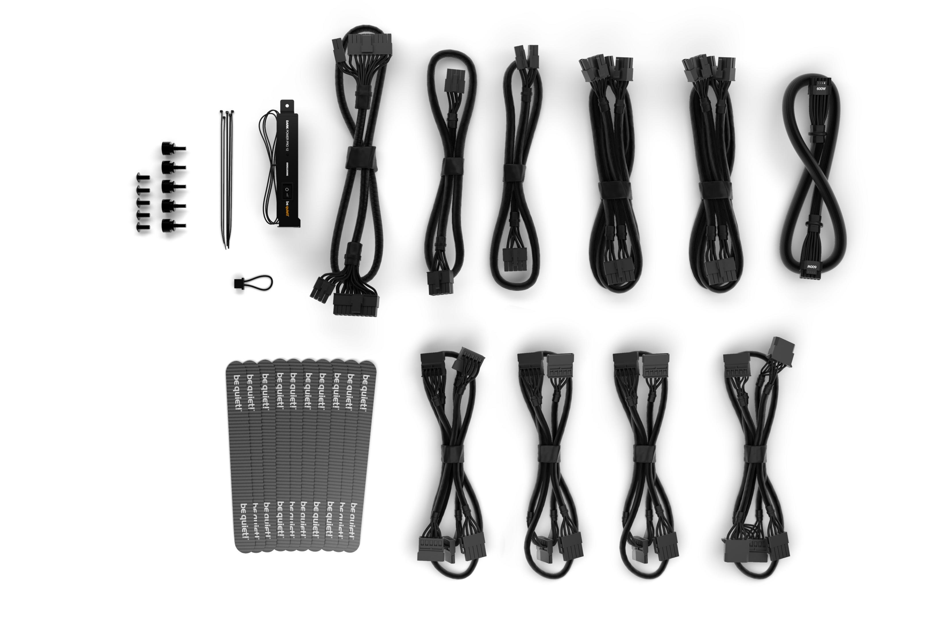 Black PC cables, screws, zip ties, and a PSU adapter on a white background.