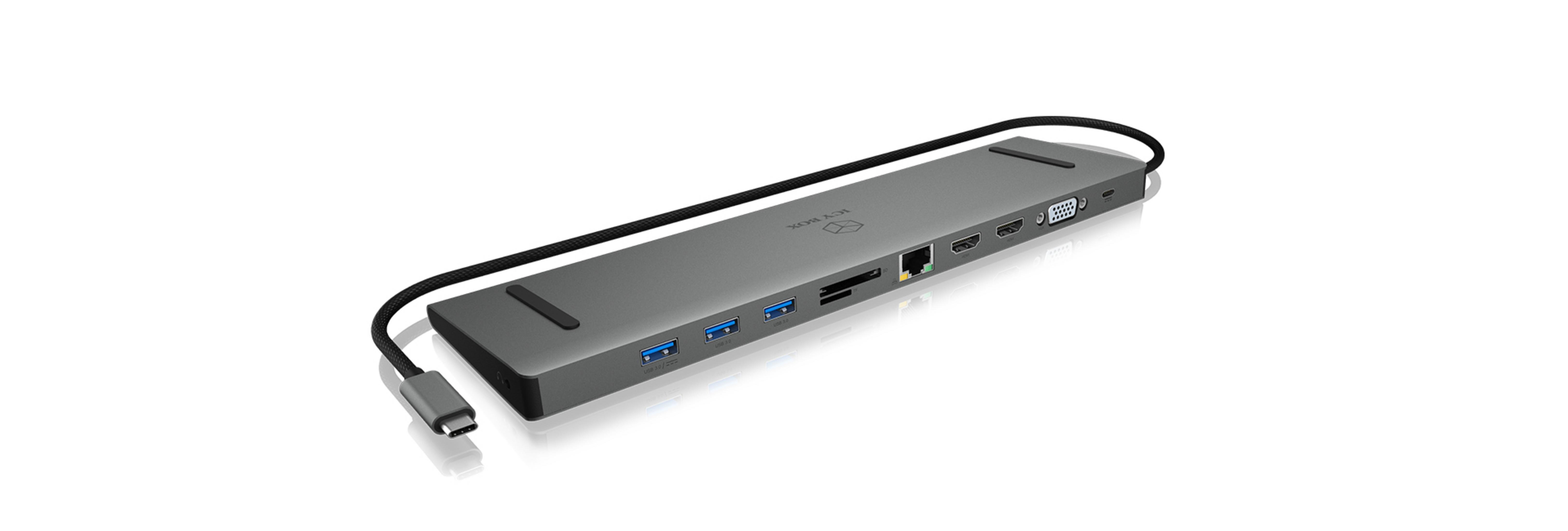 Grauer USB-C-Hub mit Anschlüssen: USB, HDMI, VGA, Ethernet, SD-Karte.