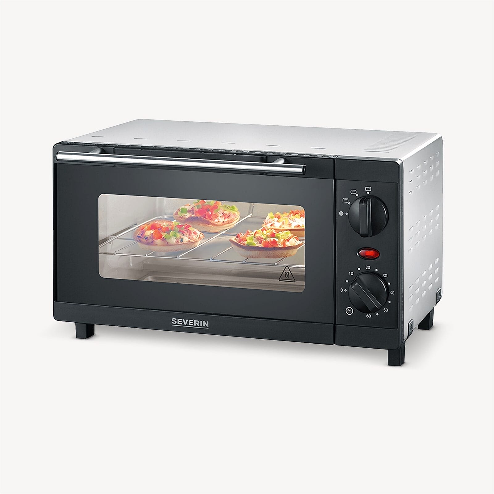 Ein kleiner schwarzer Ofen mit vier Mini-Pizzen auf dem Rost.