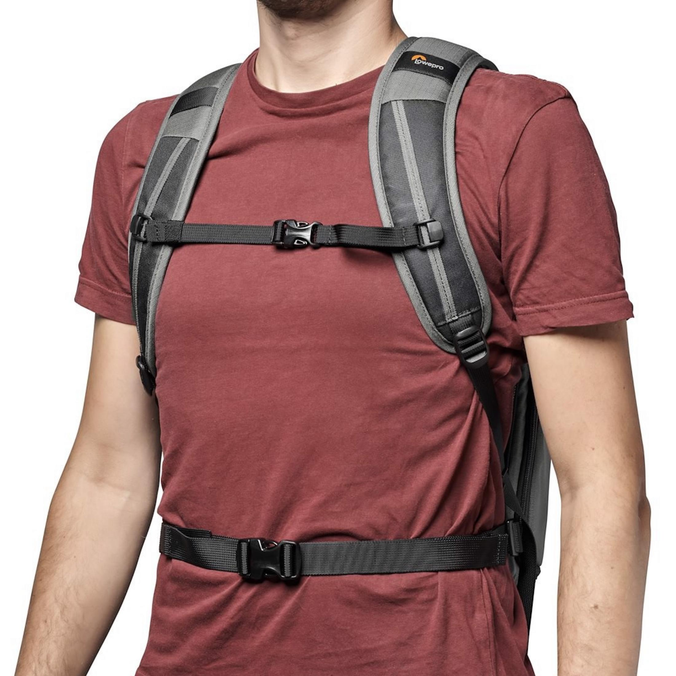 Person wearing a backpack, chest view, showing shoulder and waist straps.