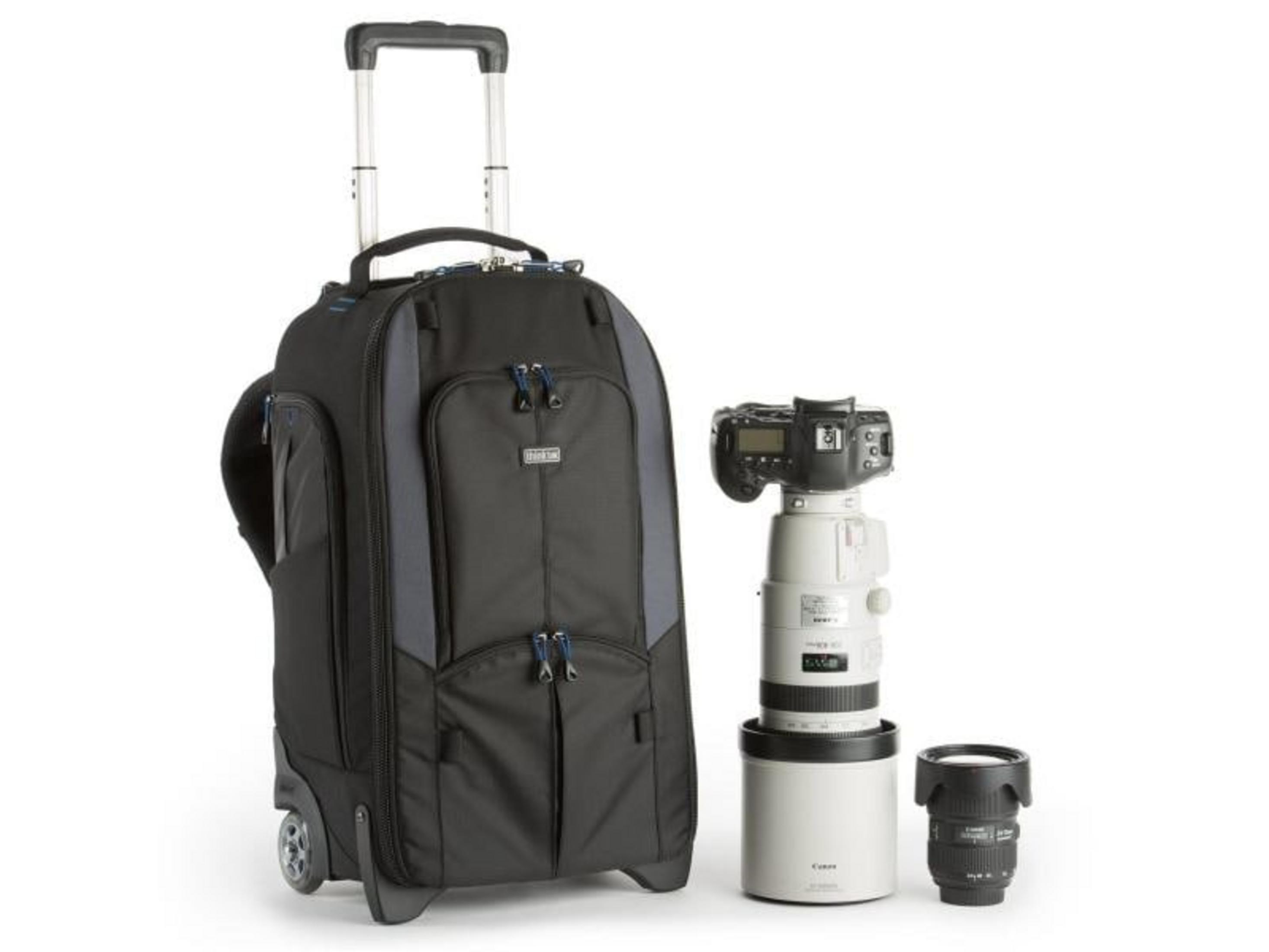 Black rolling camera bag with lenses and camera.