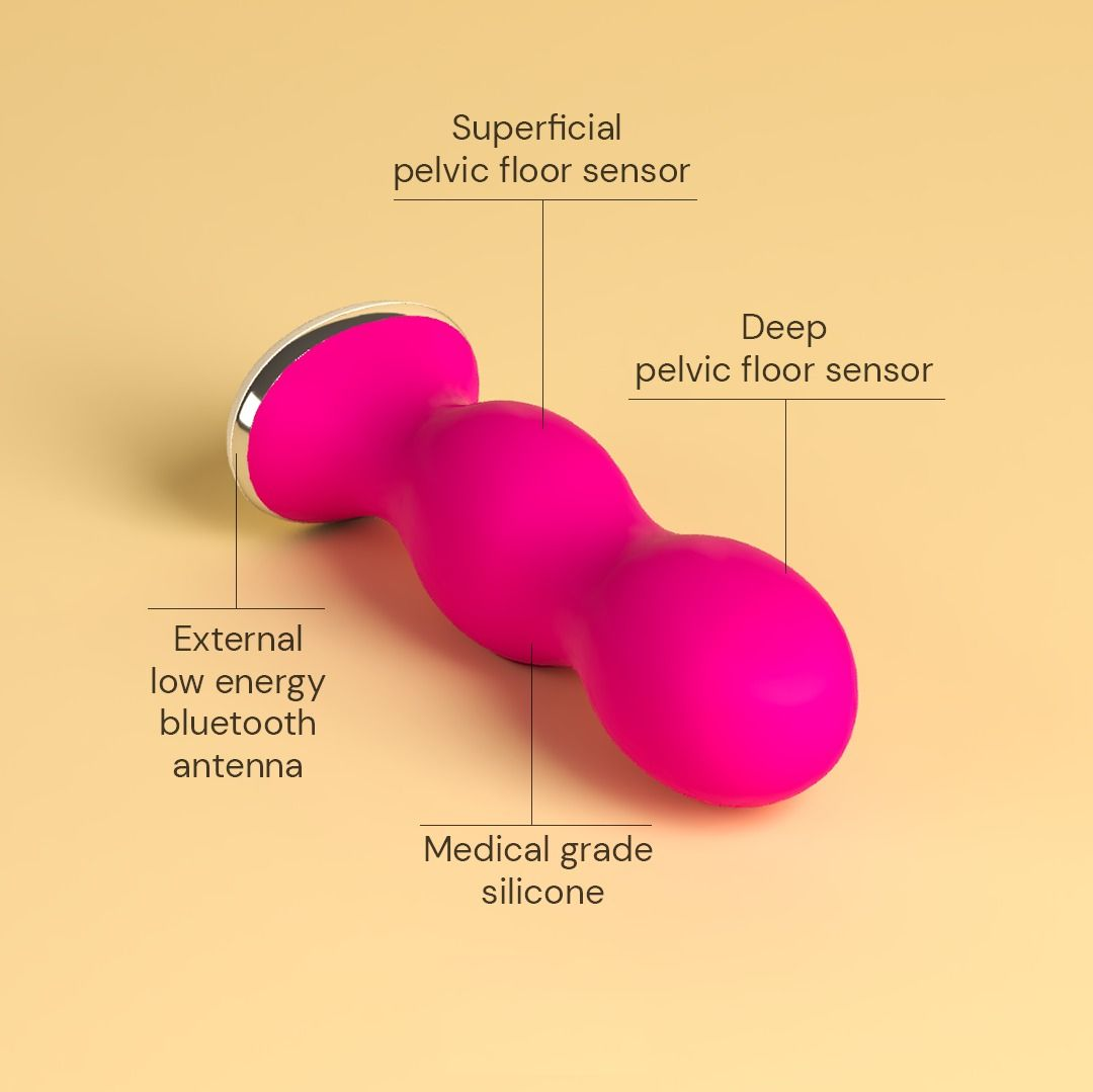 Ein leuchtend pinker Beckenbodentrainer mit Beschriftungen für Sensoren und Material.