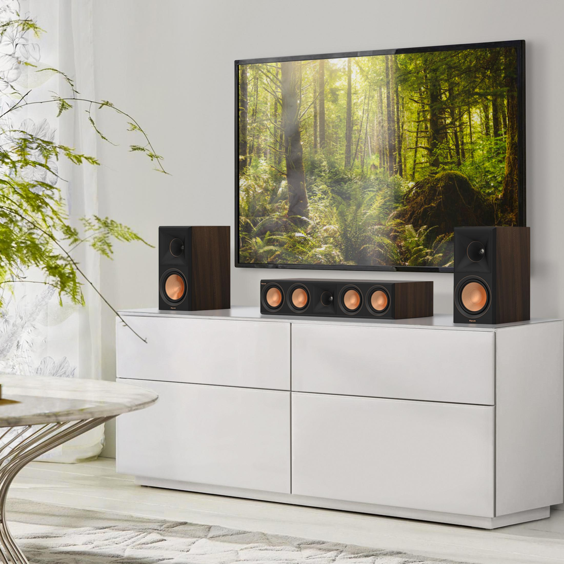 Holz lautsprecher und ein Fernseher mit Waldbild stehen auf einem weißen Schrank.