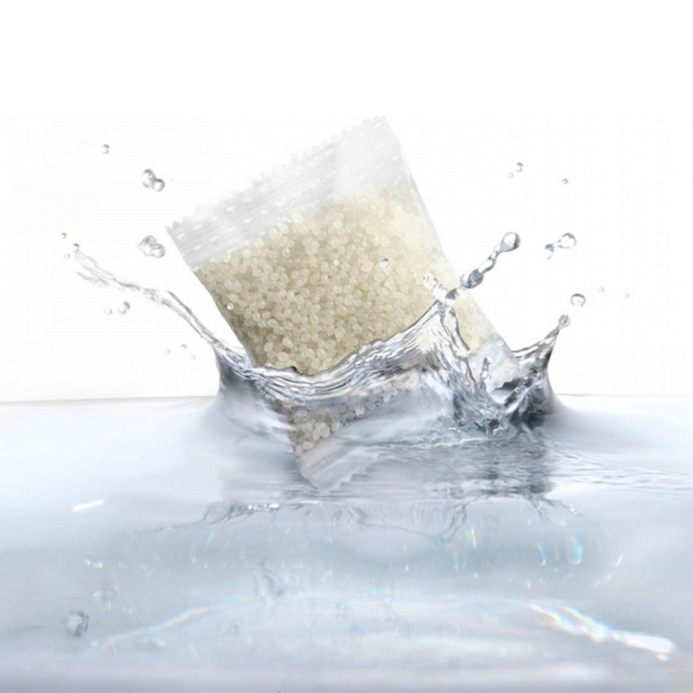 A bag of small beads splashes into water.