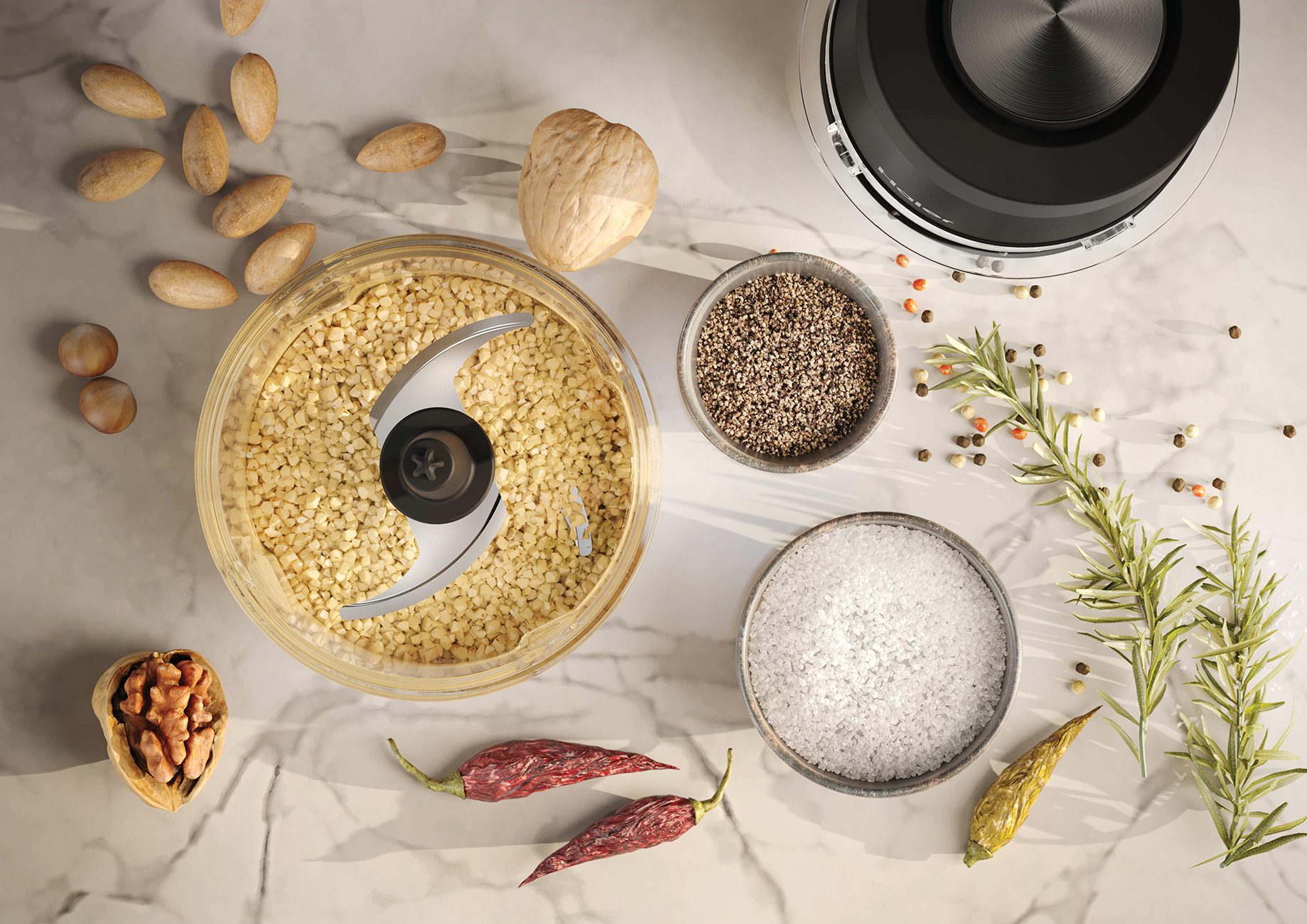 Un picador de alimentos con nueces picadas, especias y hierbas en encimera de mármol.