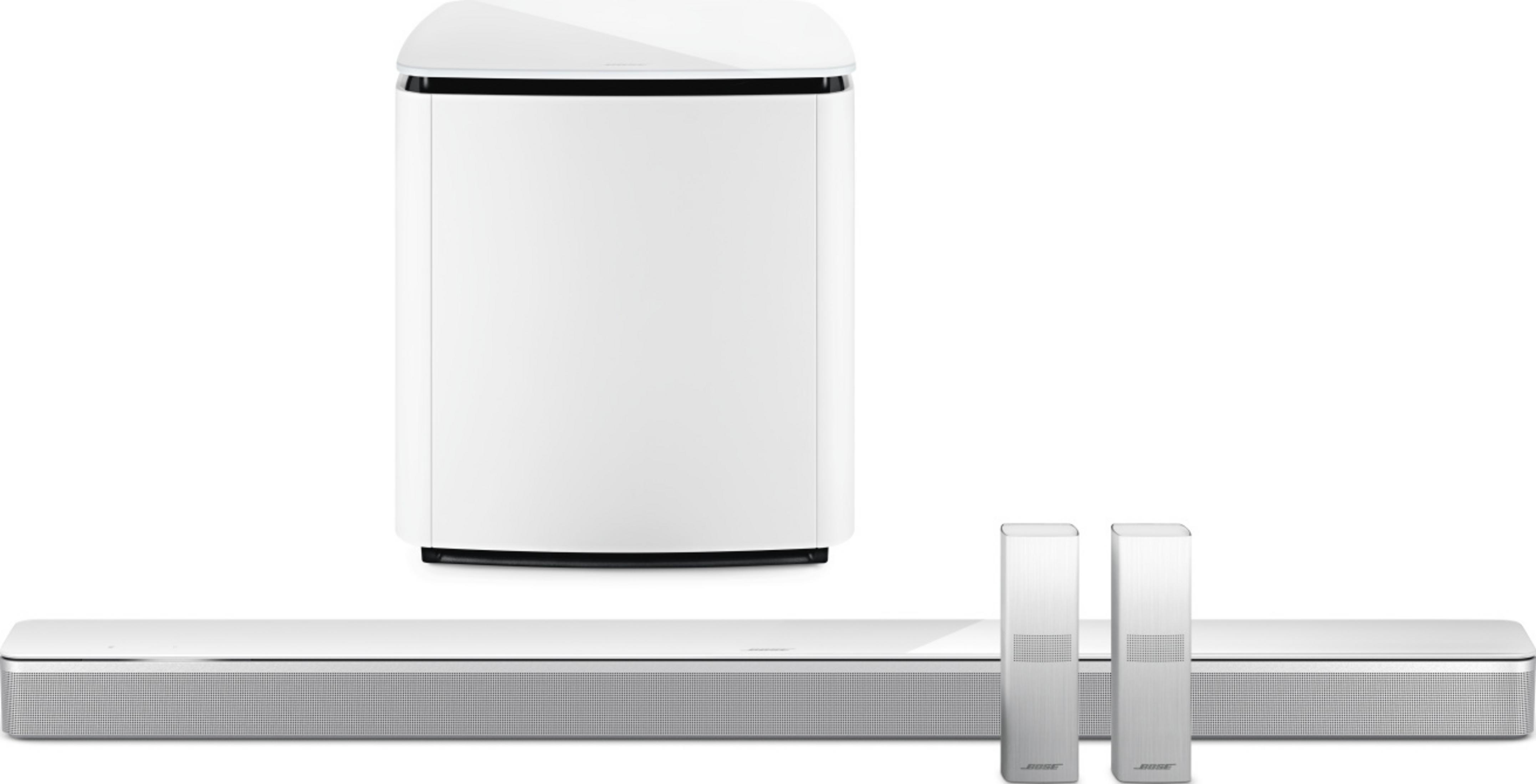 Weiße Soundbar mit Subwoofer und zwei Fernbedienungen auf weißem Hintergrund.