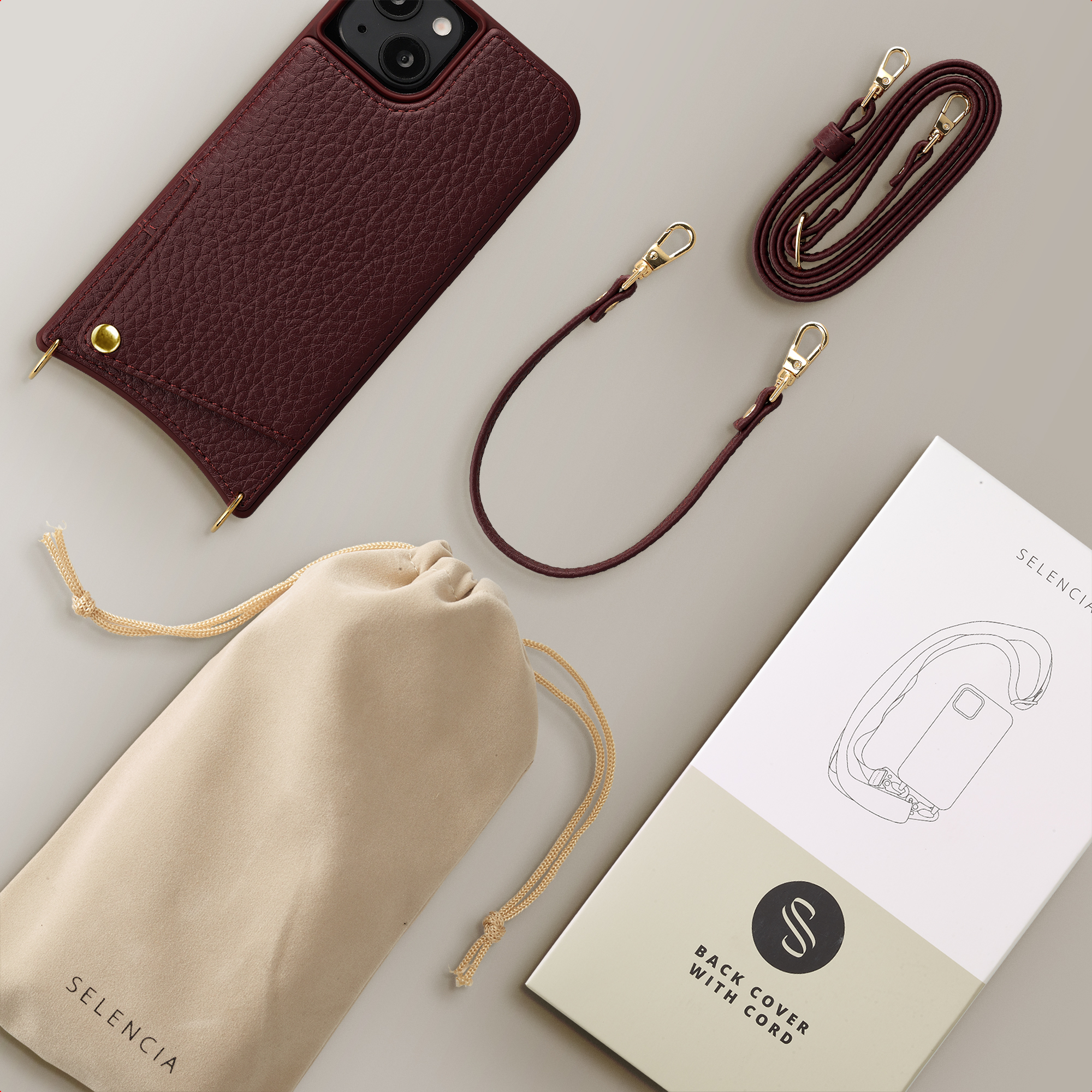 Ein dunkelrotes Leder-iPhone-Cover mit einem Beutel und einem Tragegurt.