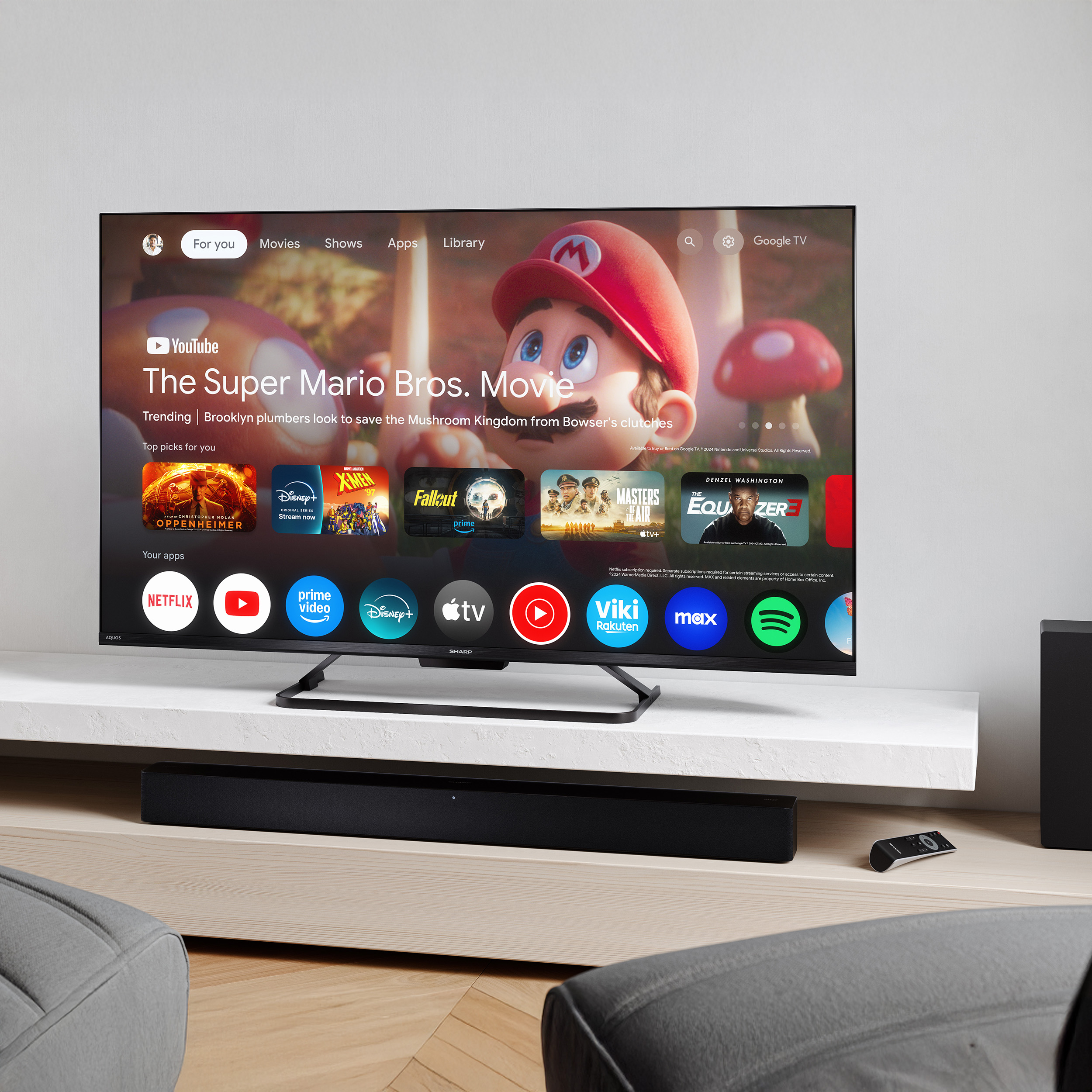 Ein moderner Fernseher zeigt die Google TV-Oberfläche mit Film- und App-Symbolen.