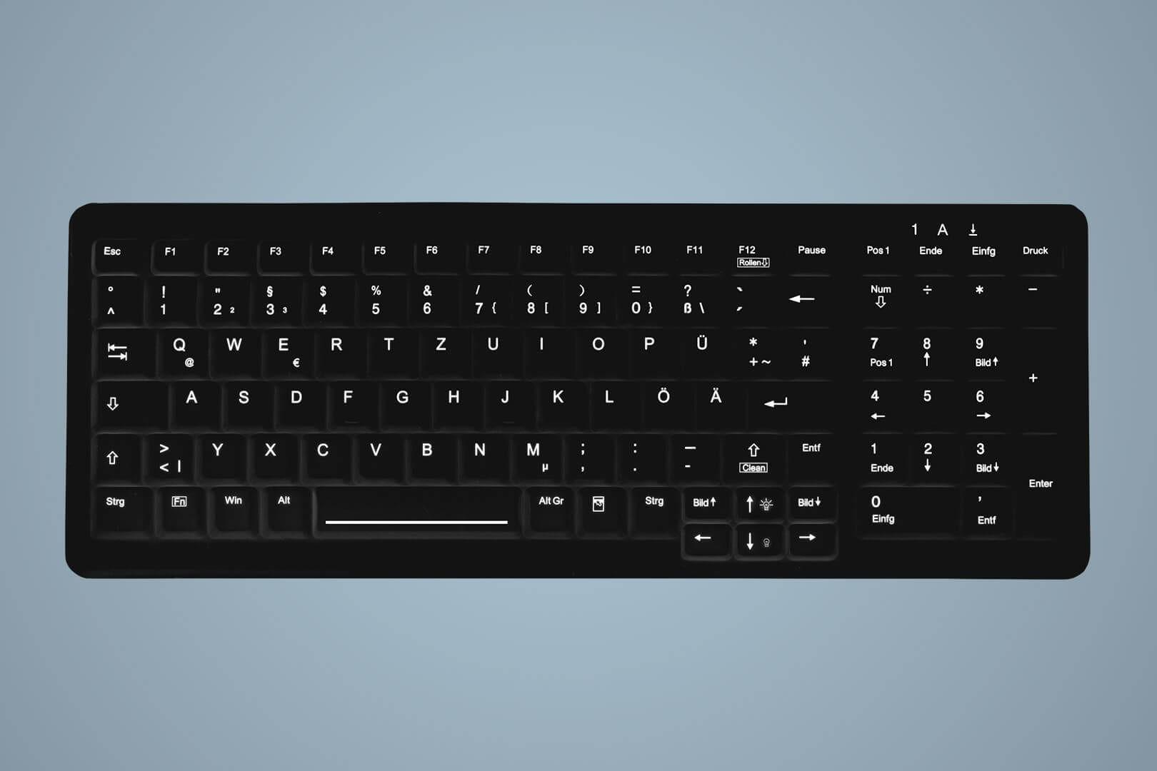 Un teclado negro con disposición QWERTZ alemana sobre fondo gris.
