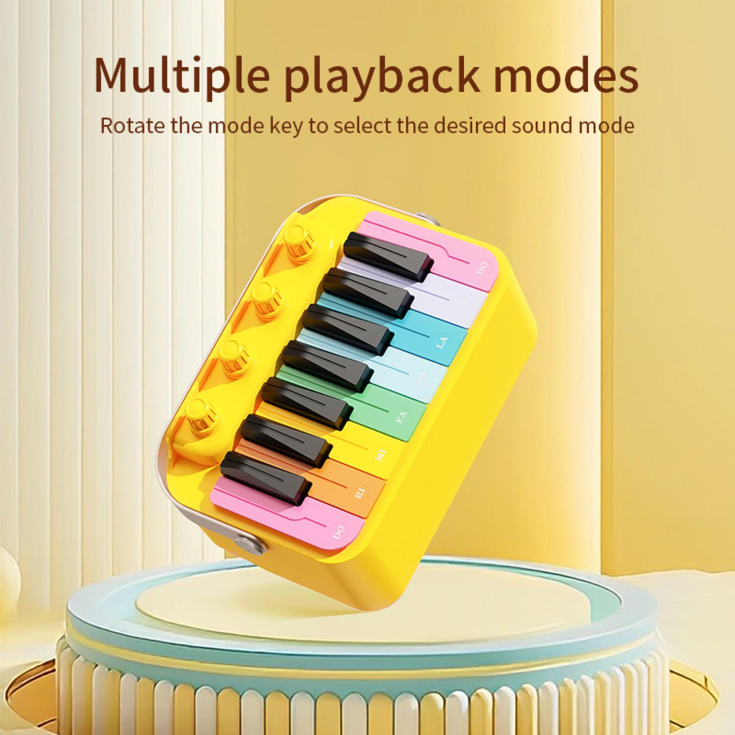 Ein gelbes Spielzeugklavier mit bunten Tasten auf einer bunten Bühne.