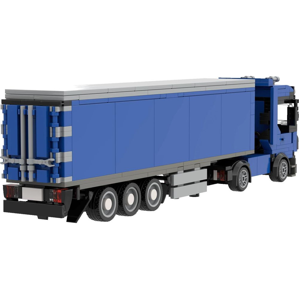 Un camion Lego bleu avec remorque sur fond blanc.