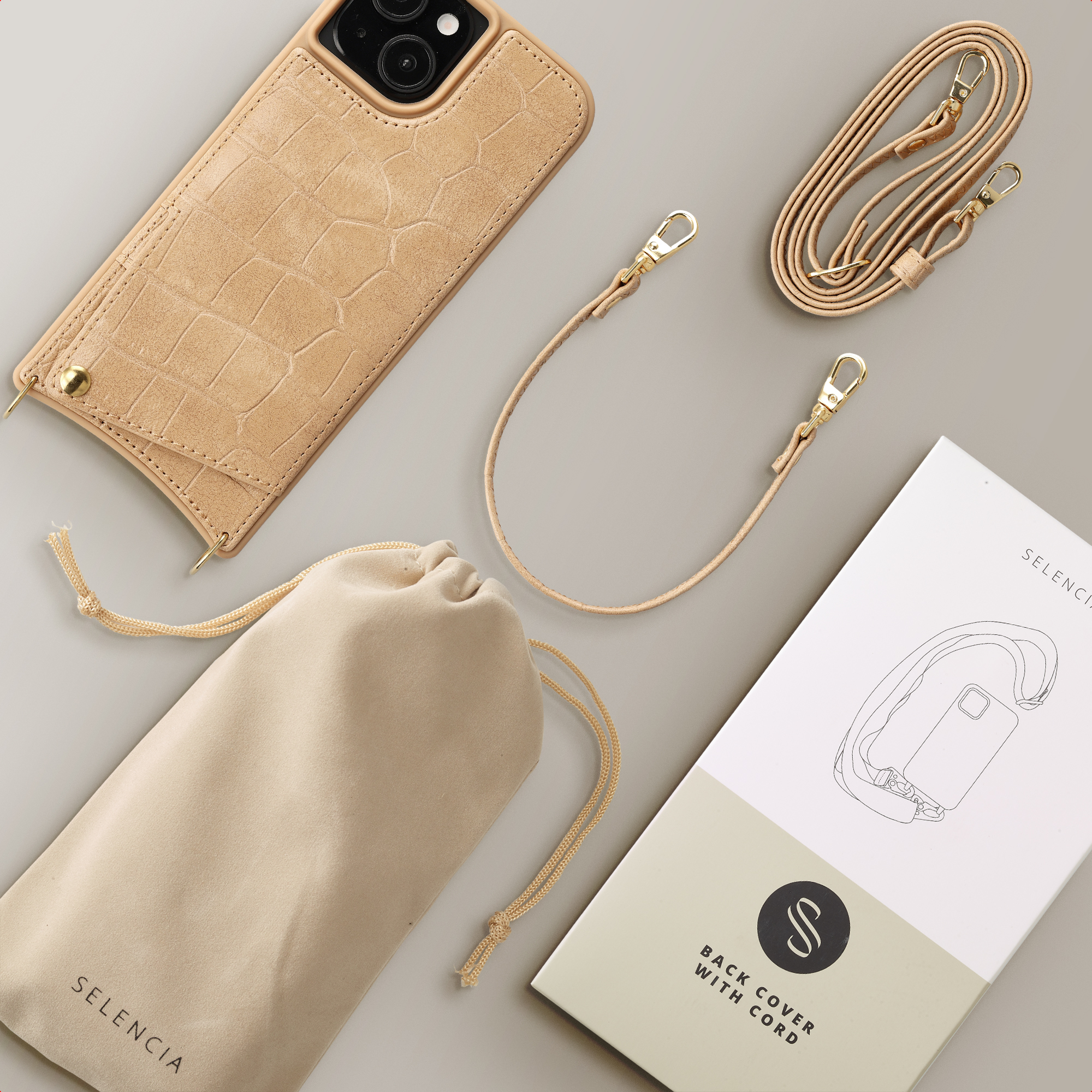 Bruine telefoonhoes met krokodillenreliëf, koord, etui en verpakking.