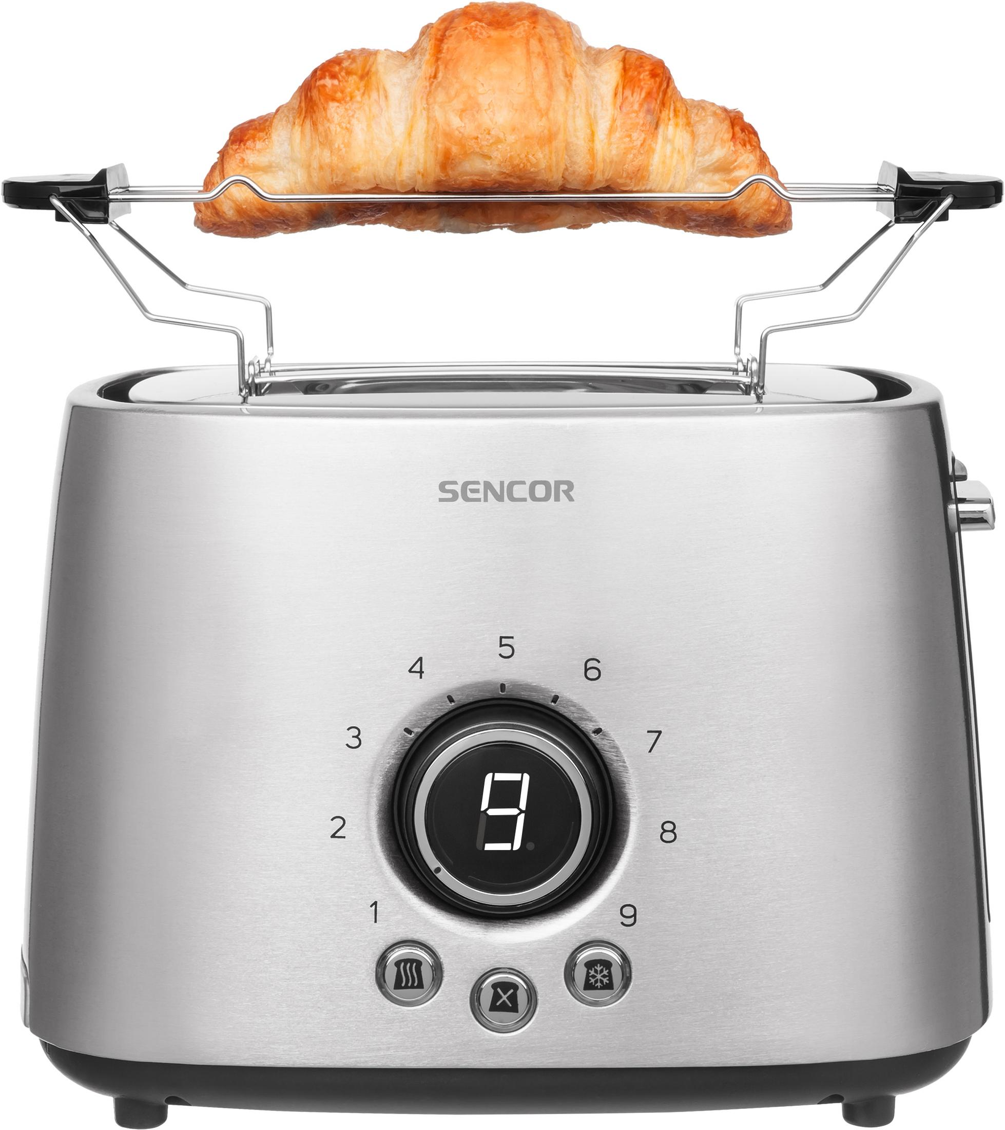 Un croissant dorato si scalda in un tostapane argentato con display digitale.