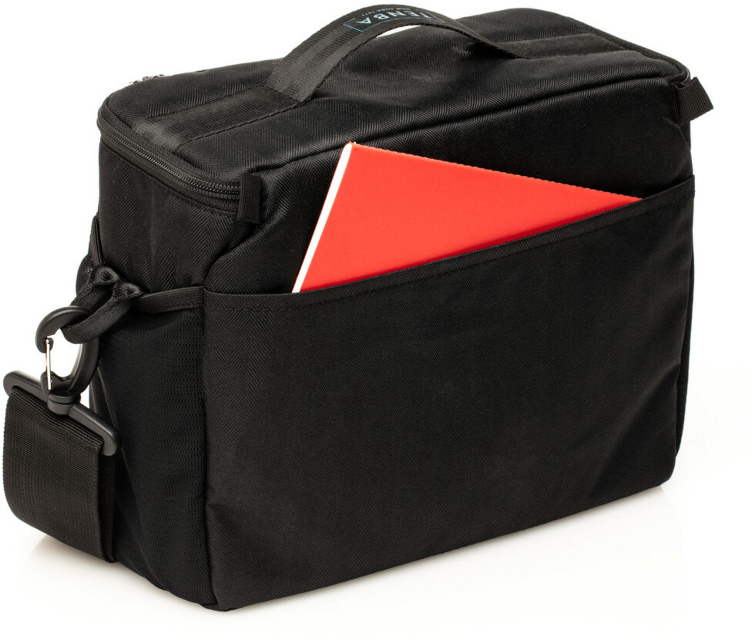 Black bag with a red notebook in its outer pocket.