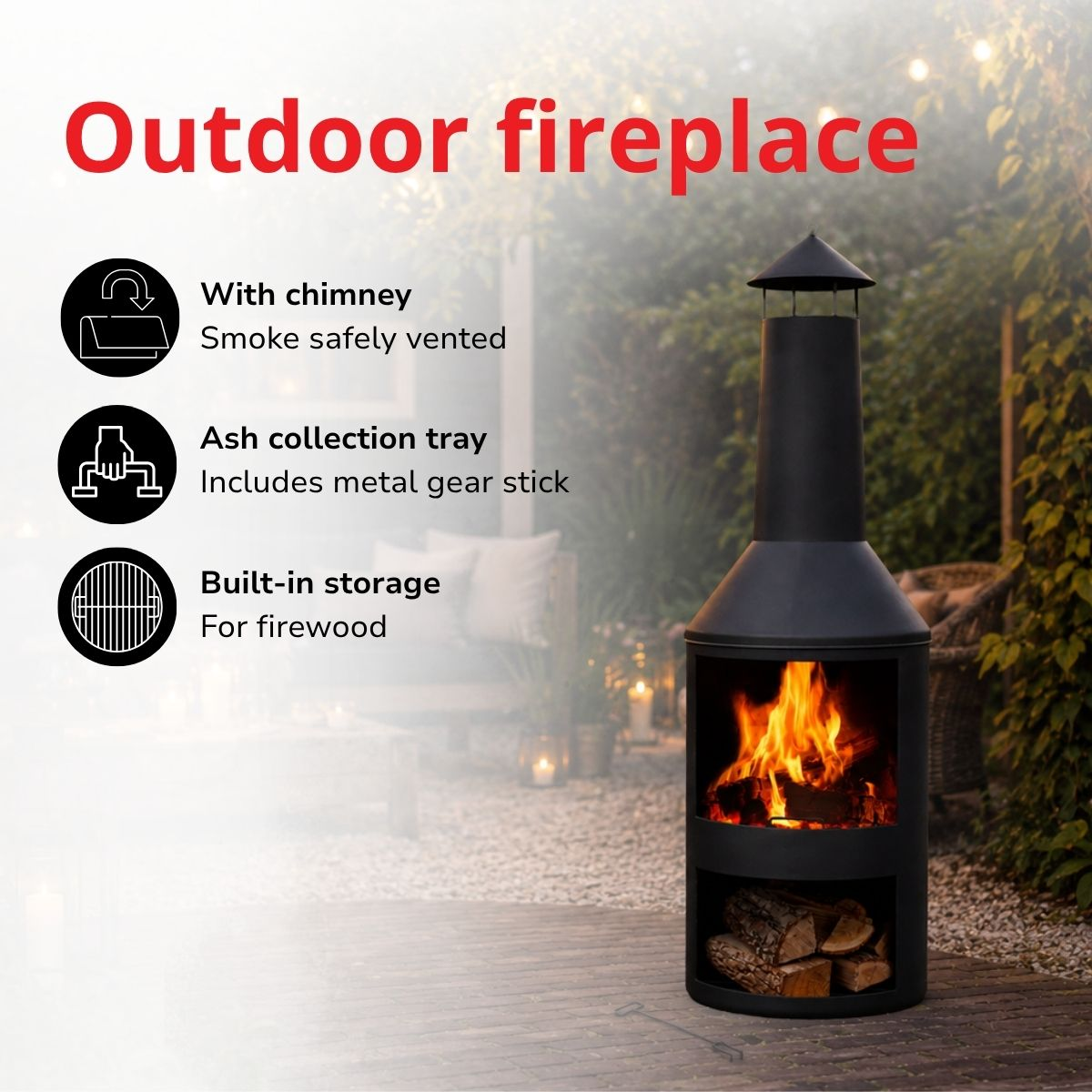 Black outdoor fireplace with wood storage below and a lit fire inside.