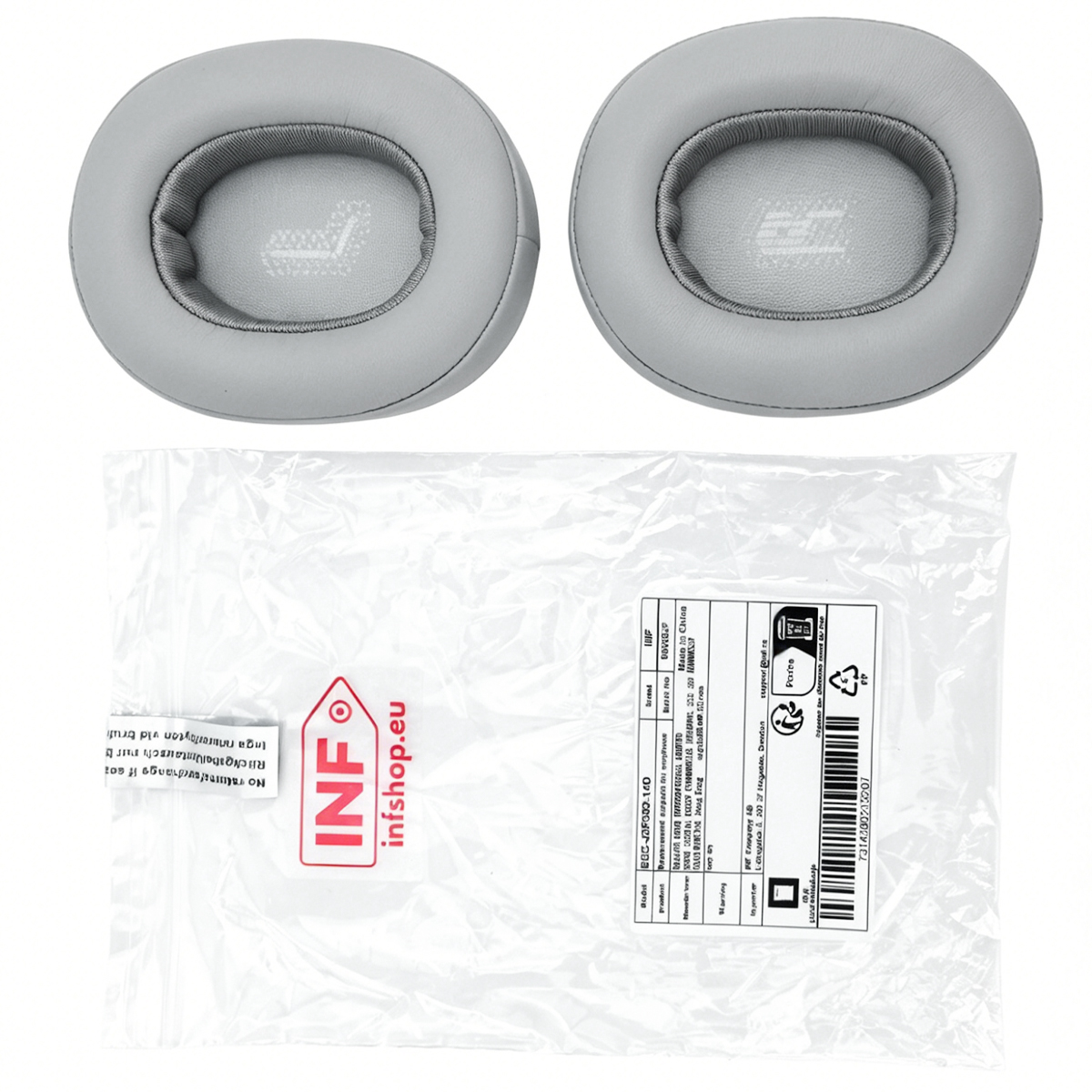 Zwei graue Ohrpolster und eine Verpackung mit Produktinformationen.