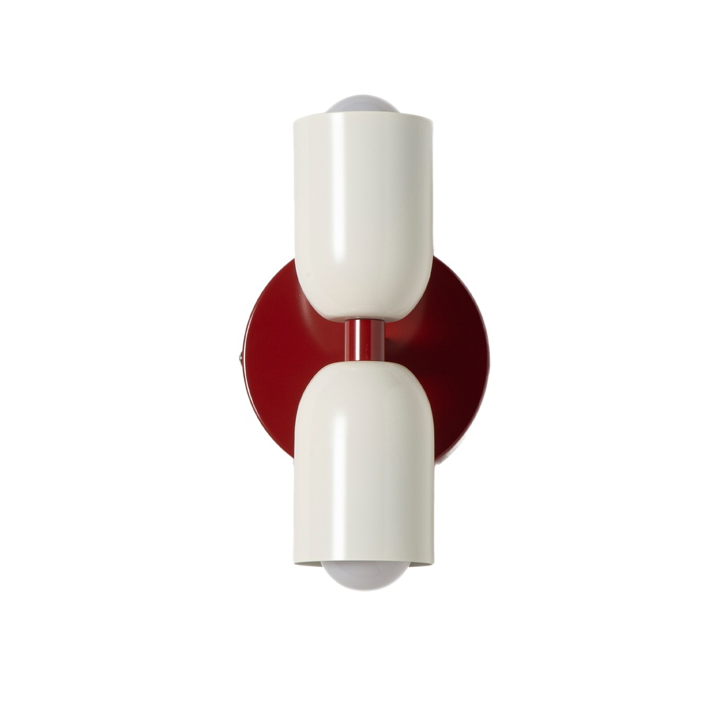 Una lámpara de pared color crema con base roja y dos pantallas.